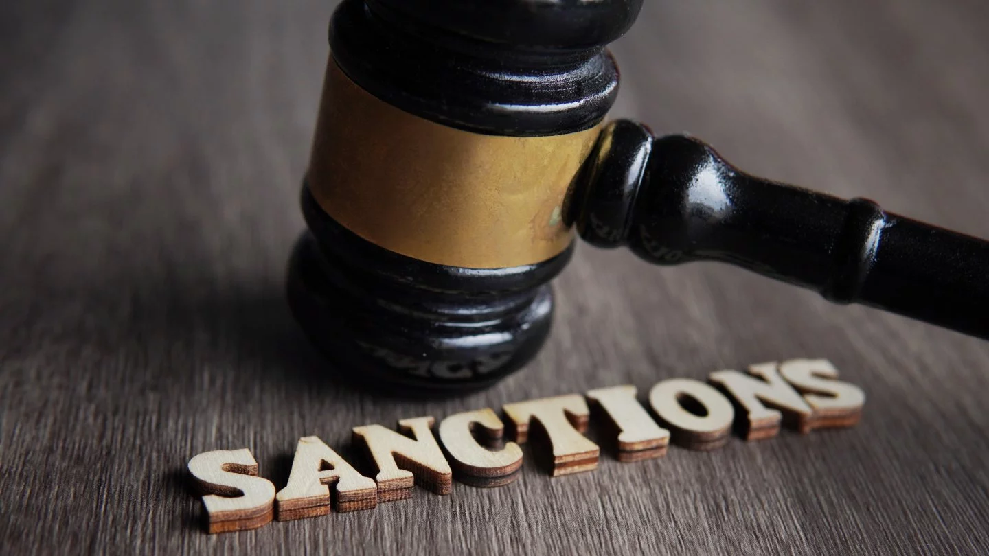judge gavel and text sanctions on wooden table 2023 11 27 05 32 06 utc