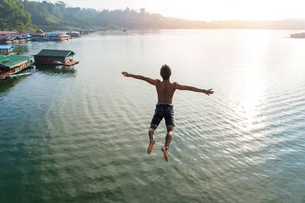depositphotos 154065590 stock photo man jumping into lake retro